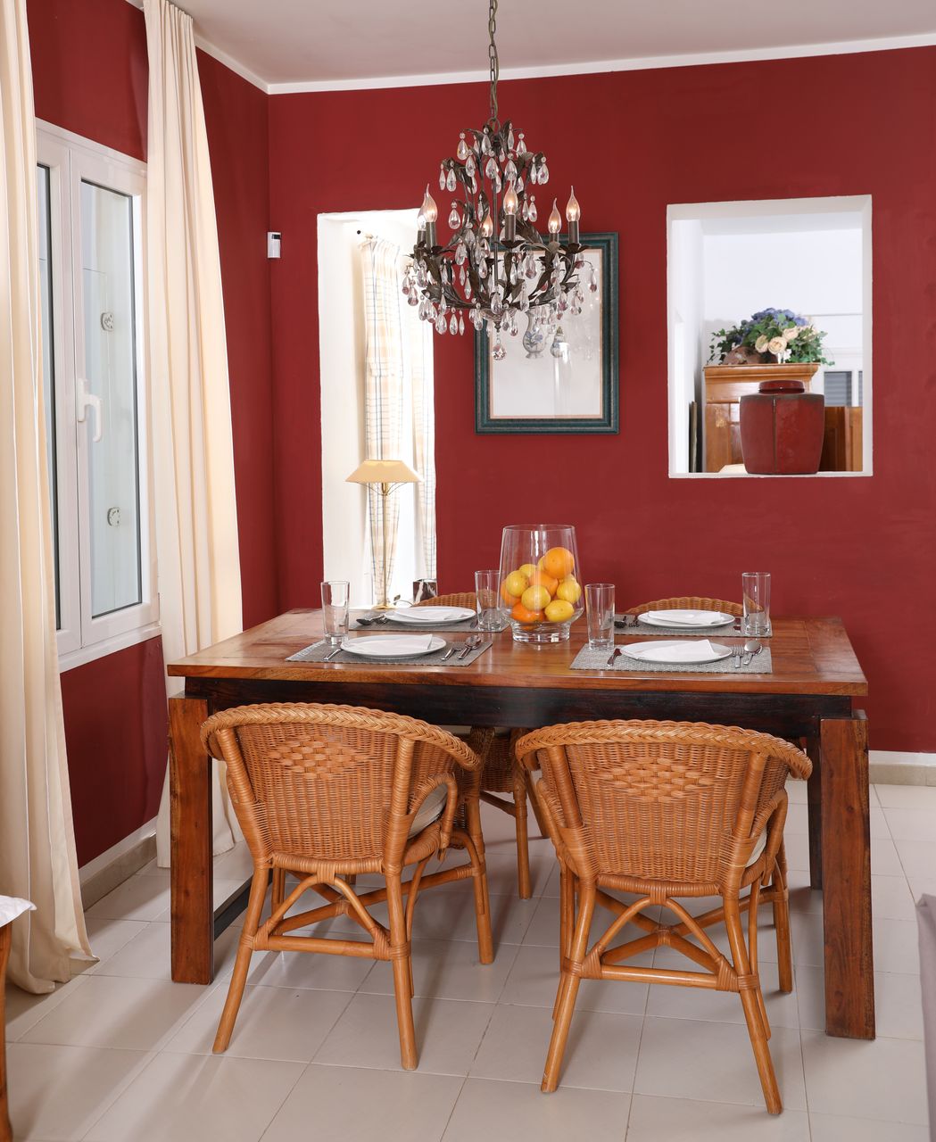 Dining area with chandelier and rattan chairs