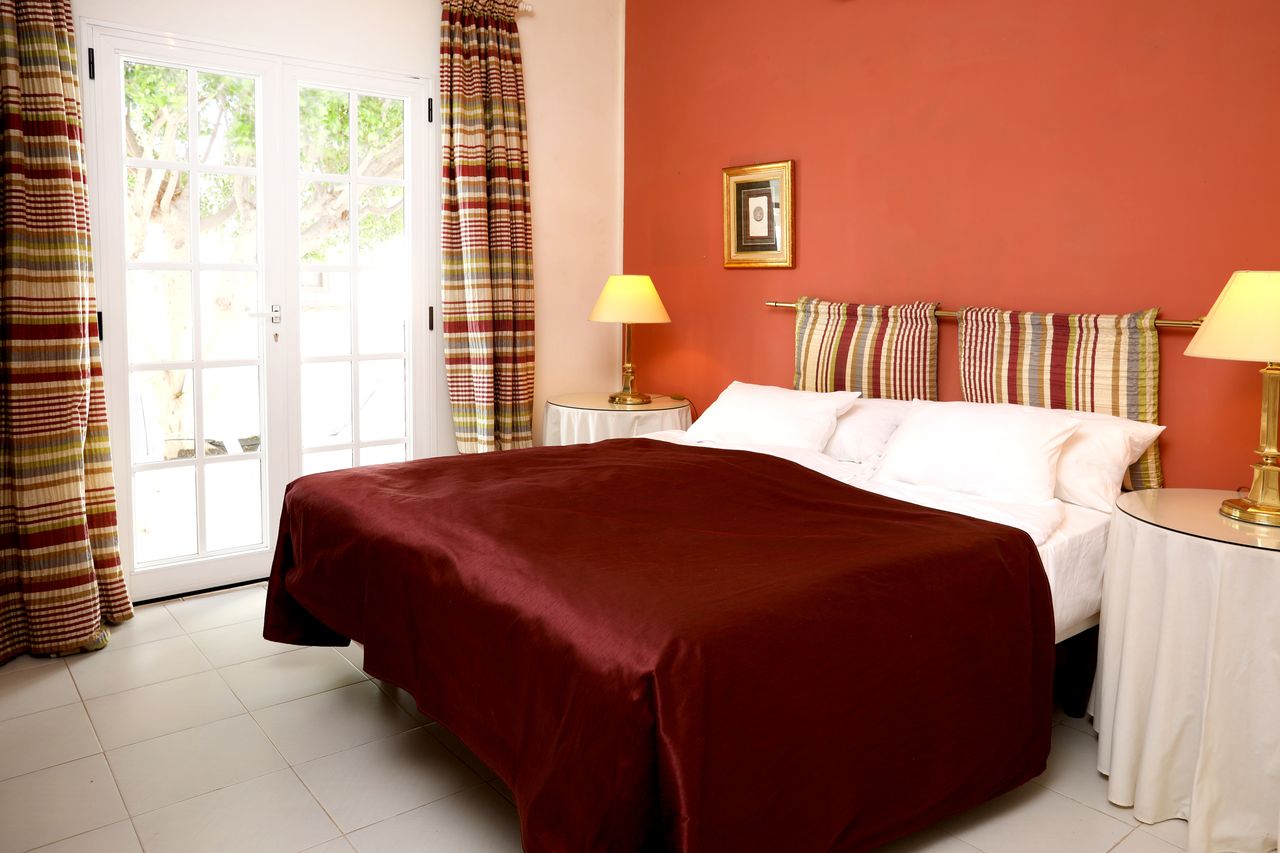 The red bedroom with French doors to the garden