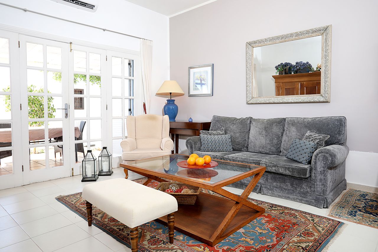 Living room with tall glazed doors to the terrace